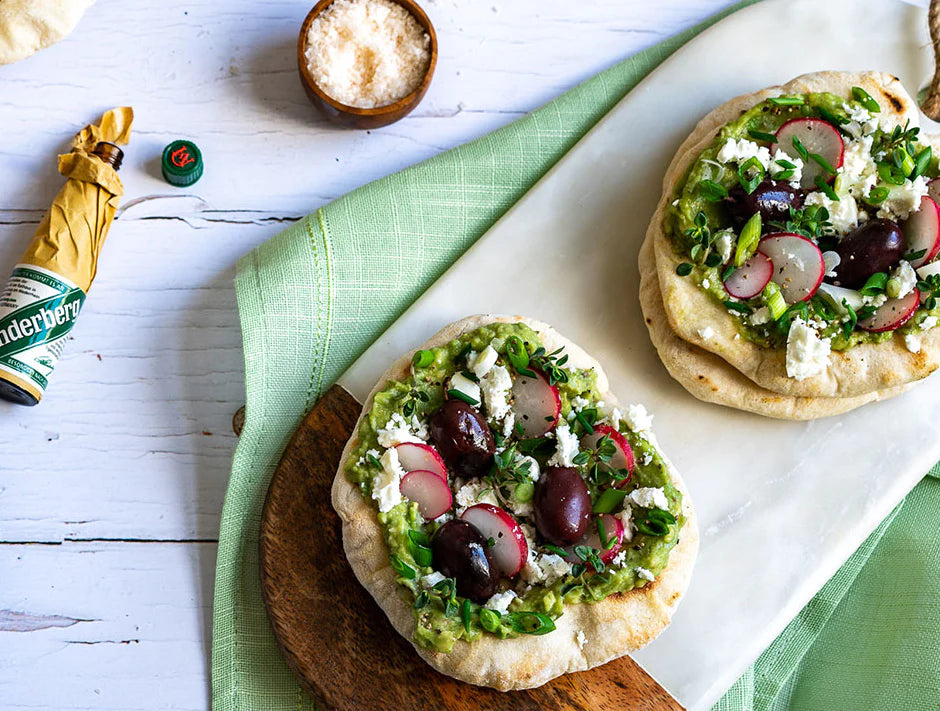 GRILLED FLAT BREAD WITH GUACAMOLE, HERBS, OLIVES AND FETA